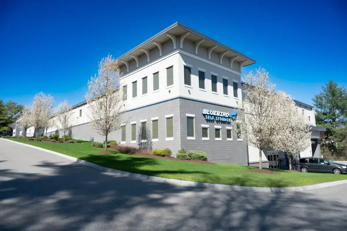 Bluebird Self Storage two-story exterior with blooming trees and blue sky