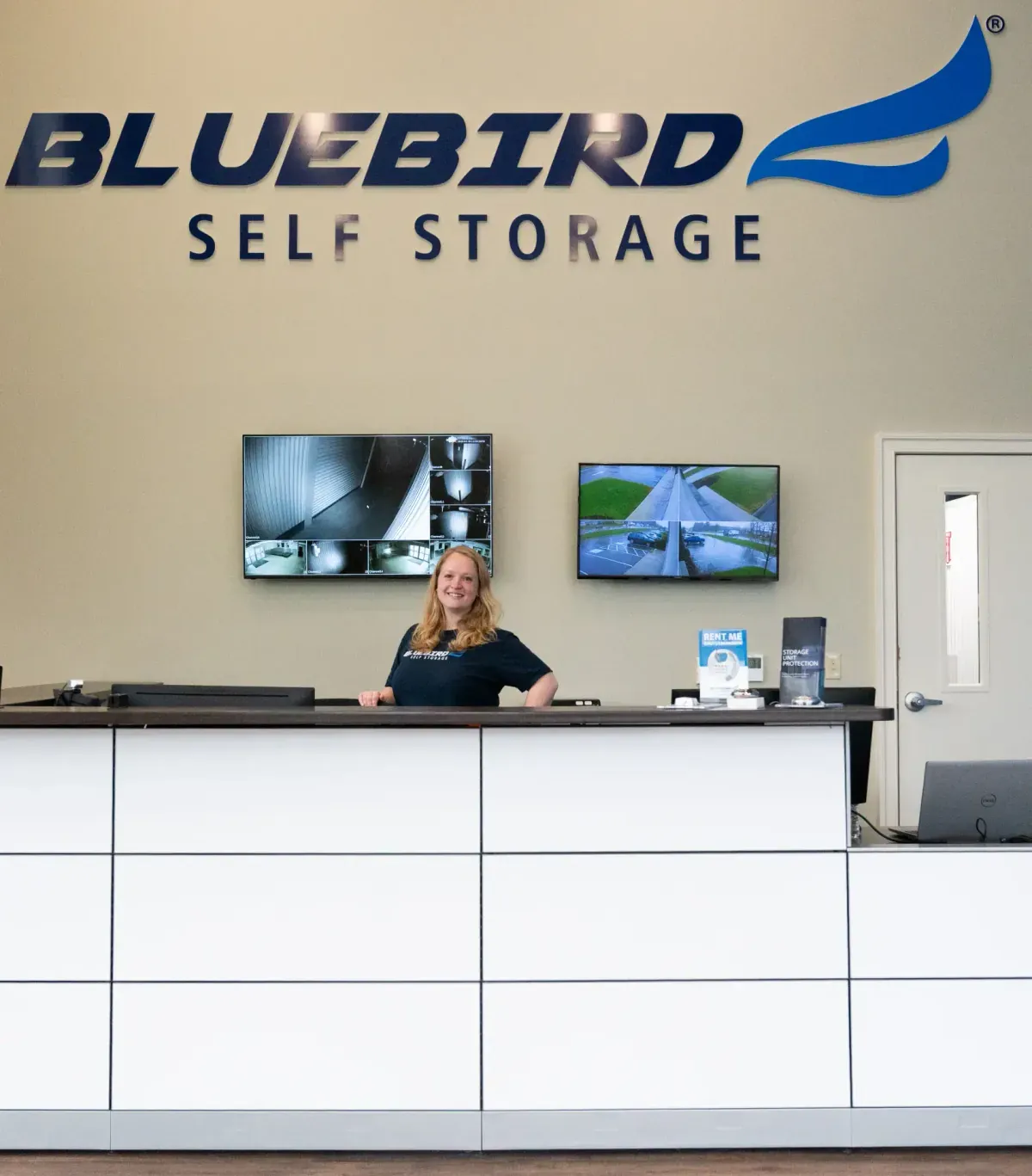 Smiling staff member at Bluebird front desk