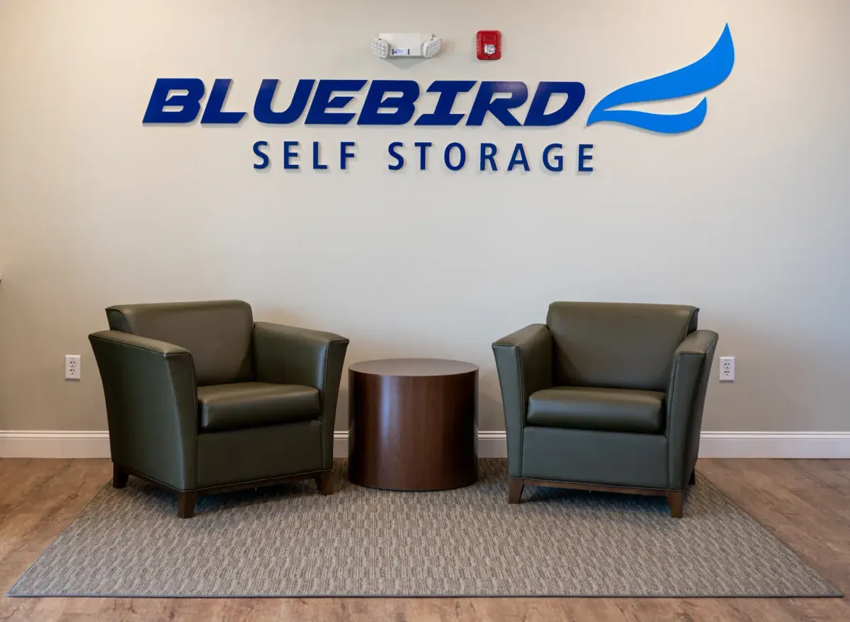 Bluebird Self Storage lobby seating area with logo