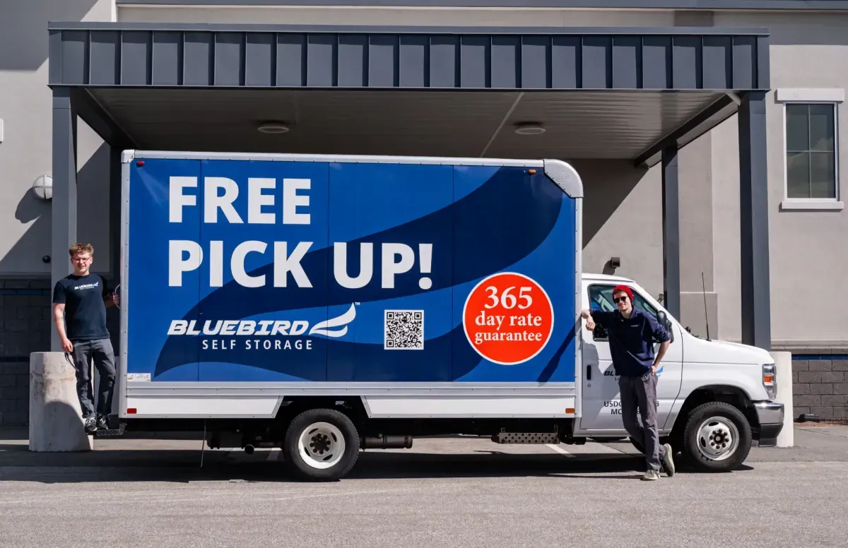 Two staff members with Bluebird free pick-up truck