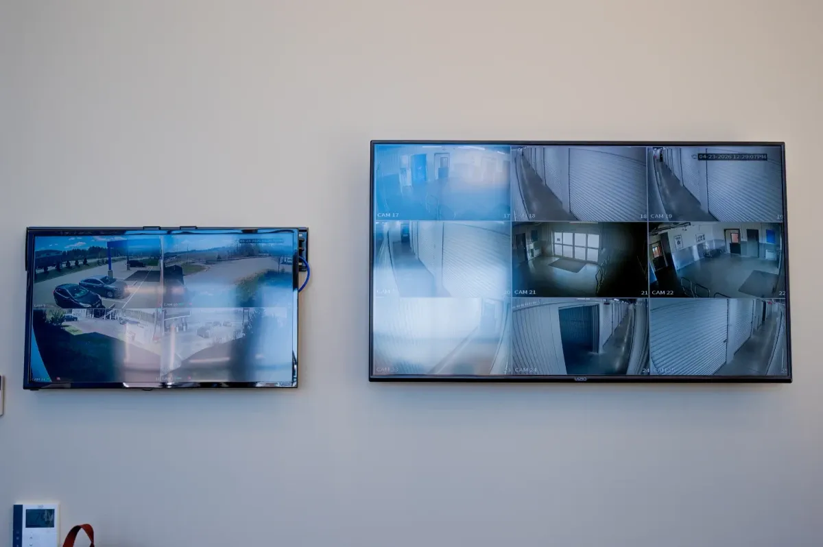 Security camera monitors displaying facility footage