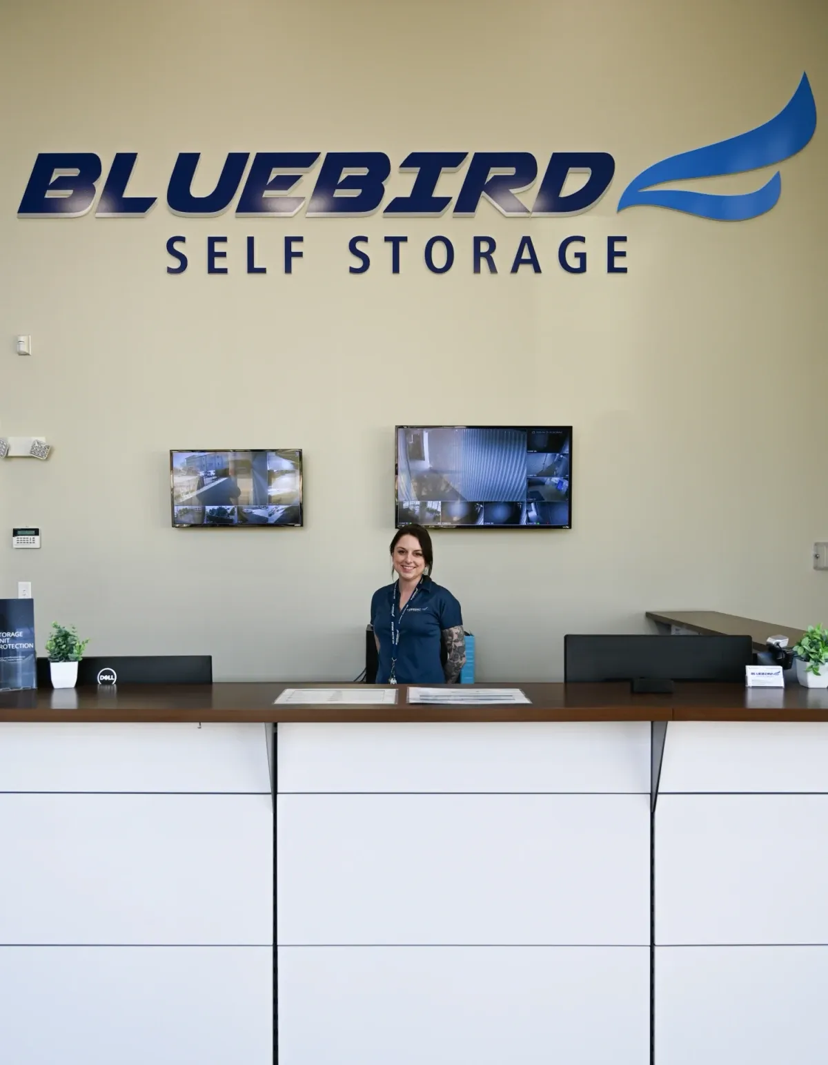 Smiling Bluebird staff member at front desk