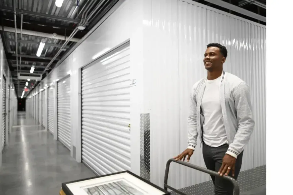 Man pushing cart with items in climate controlled storage facility